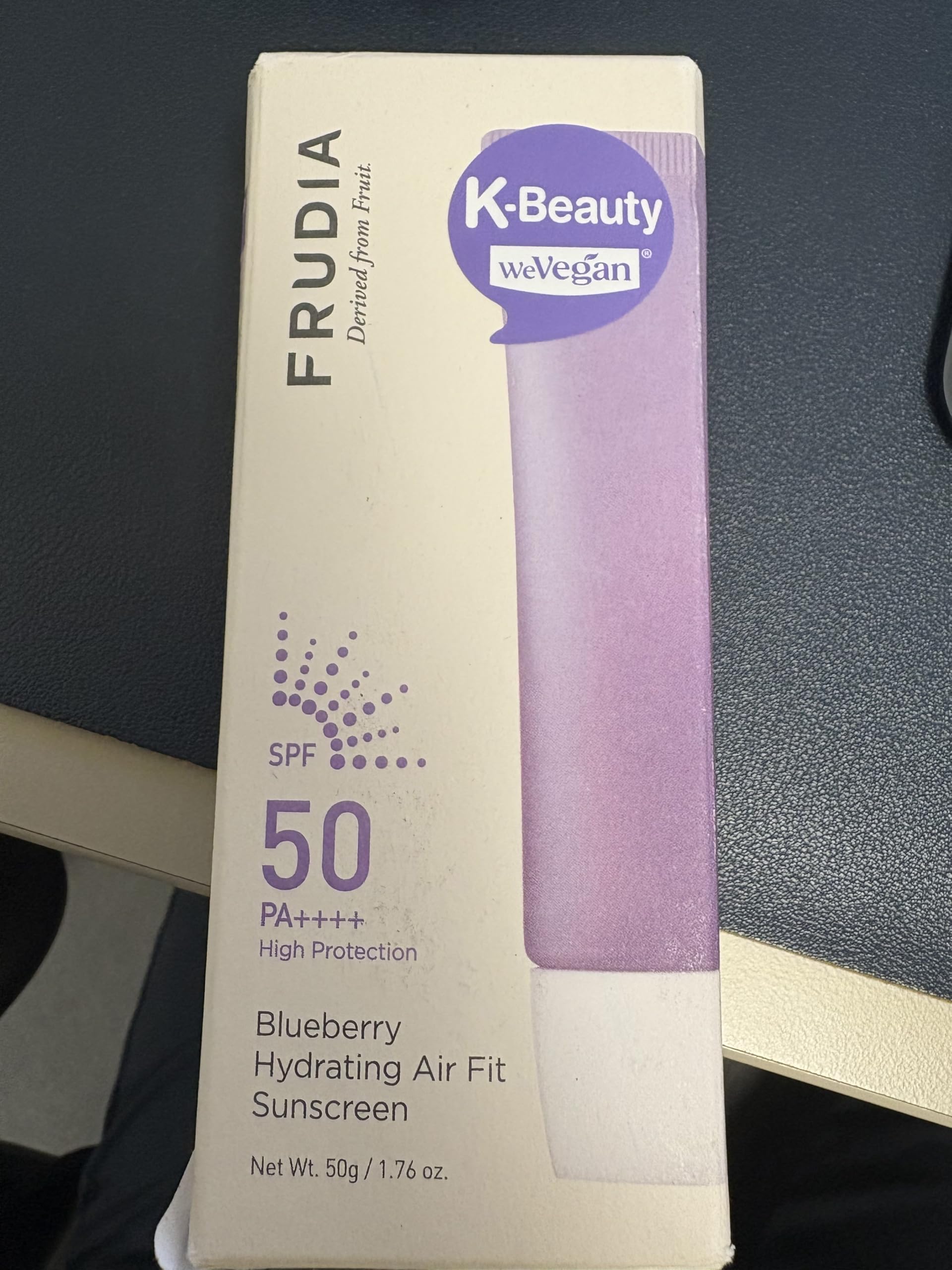 FRUDIA Blueberry Hydrating Air Fit Sunscreen SPF50 protection in bright daylight.