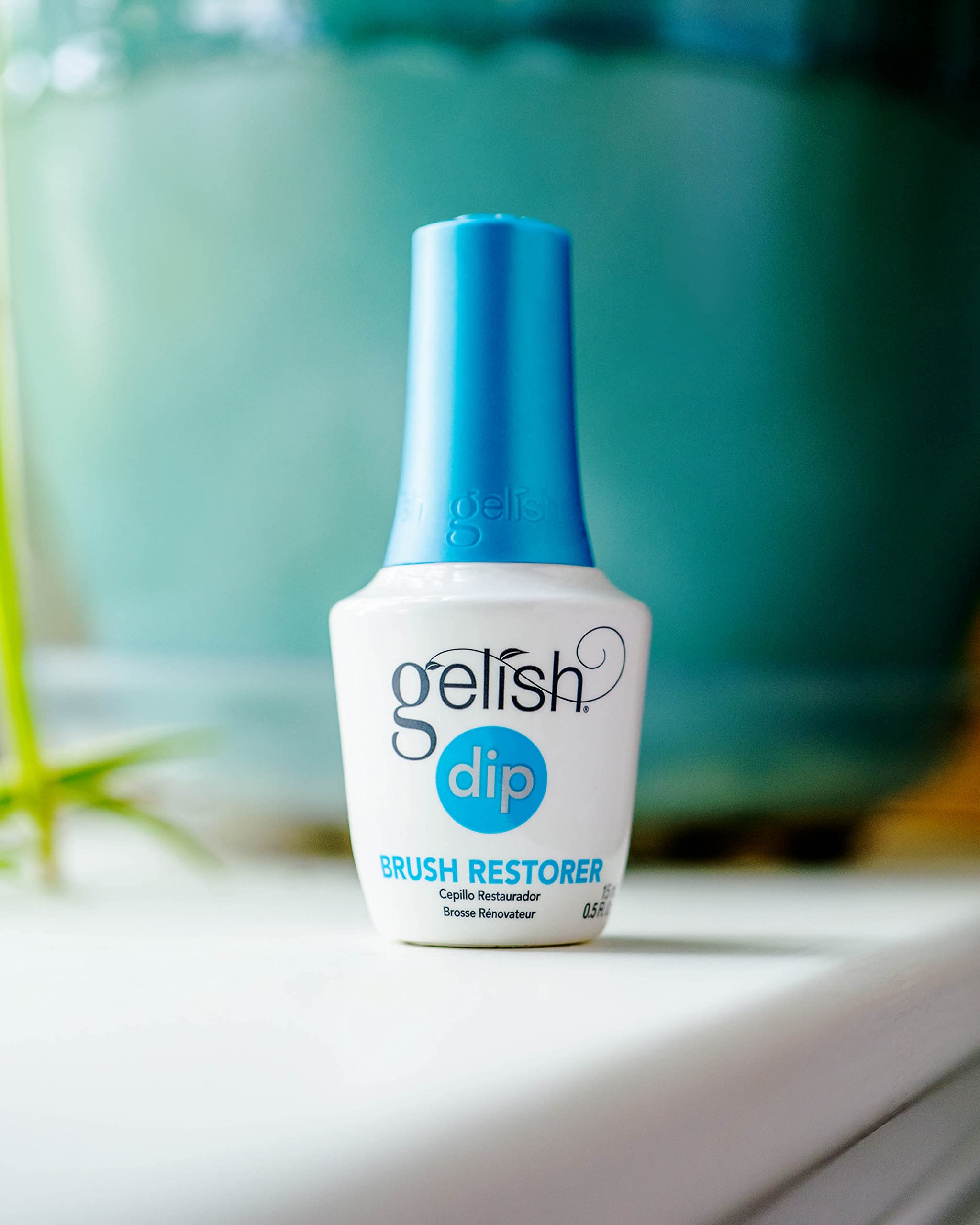 Gelish Dip Basix Top Coat bottle gleaming gloss for lasting shine.