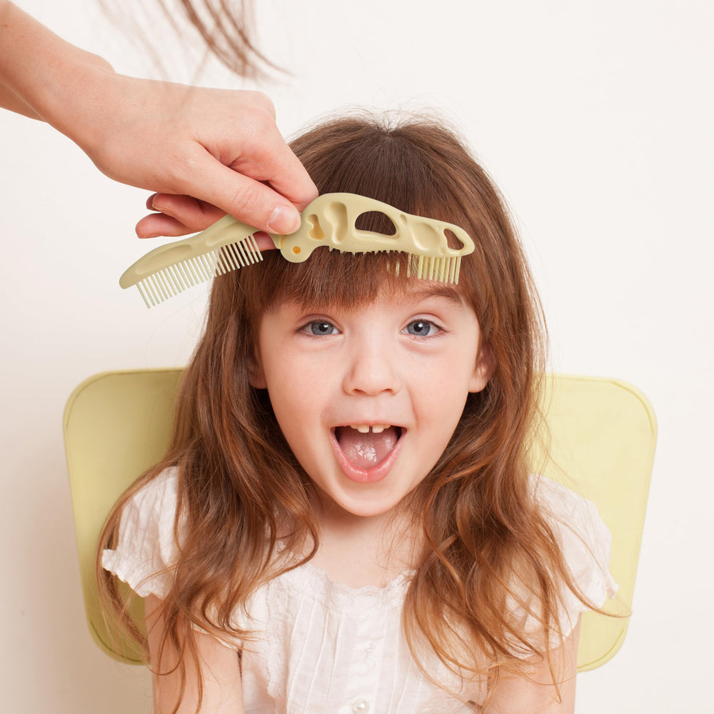 Genuine Fred Bonehead travel-size grooming tool fits diaper bags for quick touch-ups.