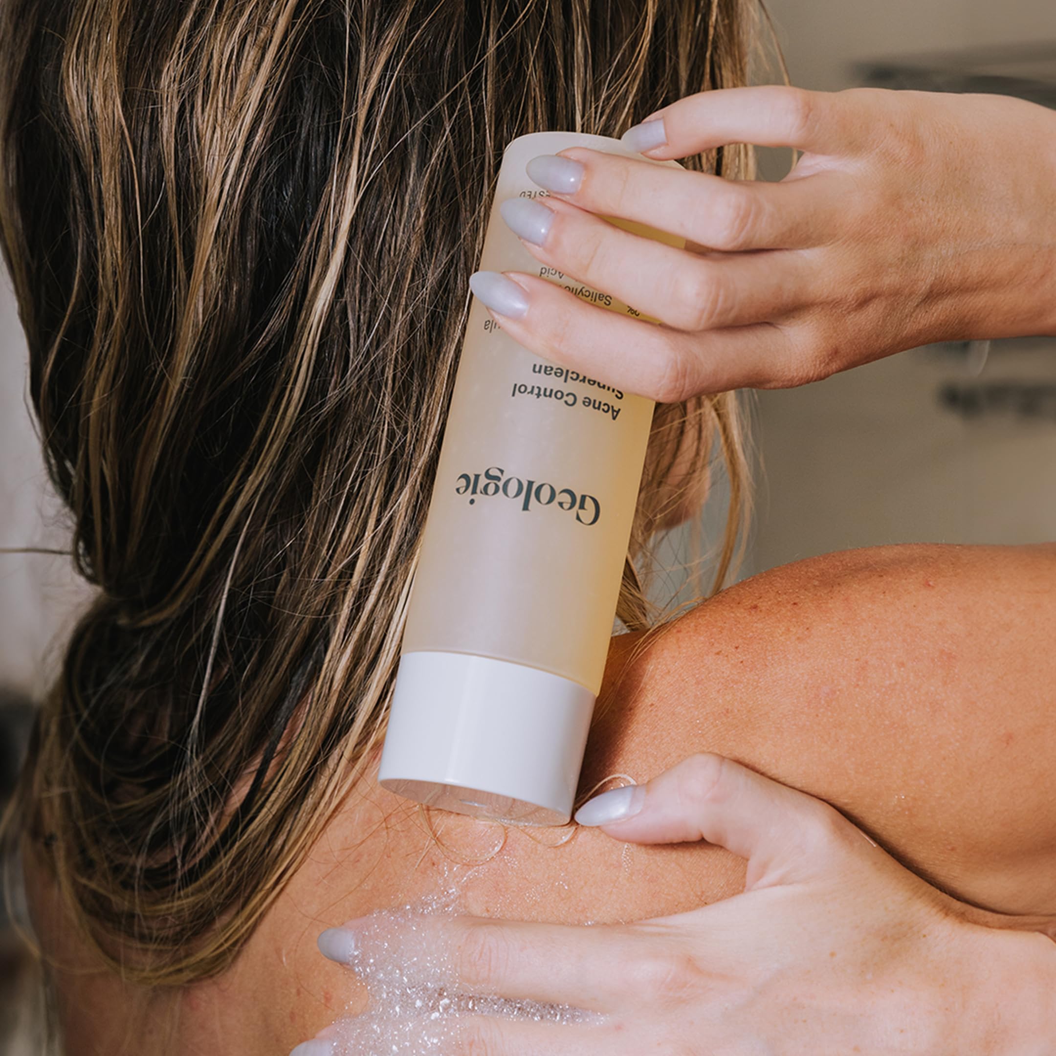 Geologie Acne Control Body Wash lather close-up showing gentle exfoliation.