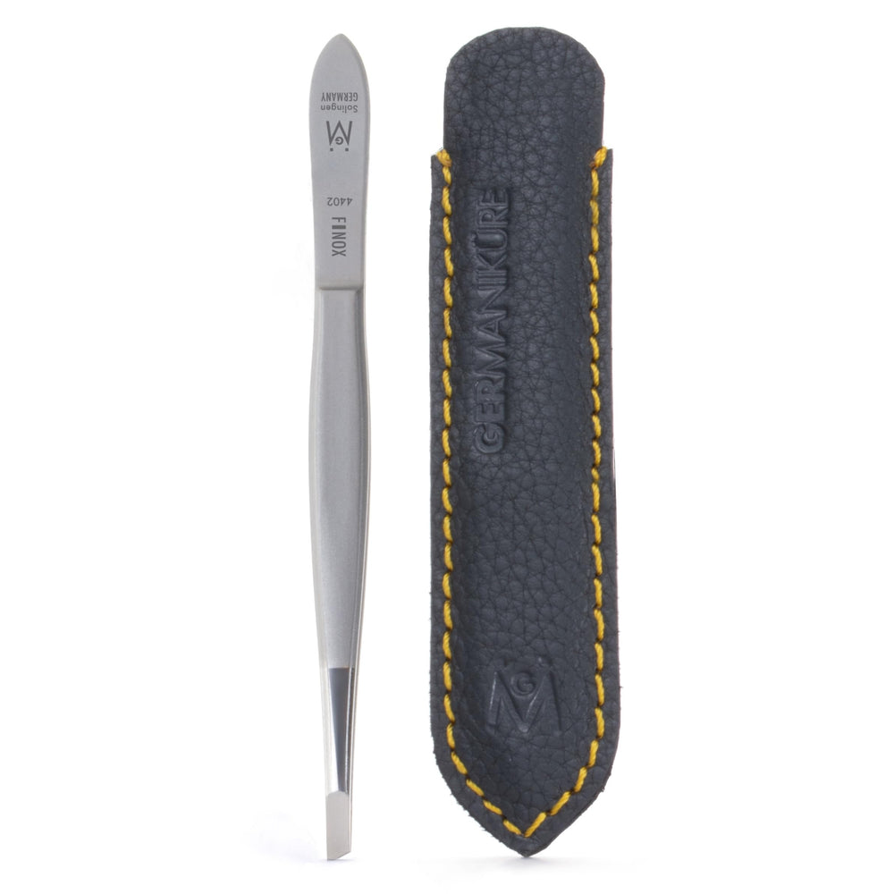 GERMANIKURE slanted tweezers in leather case for precise grooming on the go.