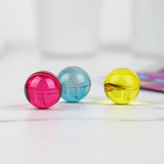  Gift Republic Liquid Spirit Rainbow Bath Pearls closeup showing glossy pearls releasing oil in water.
