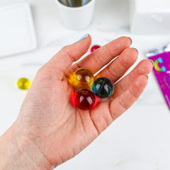  Gift Republic Liquid Spirit Rainbow Bath Pearls dissolving in water highlighting tropical scent.
