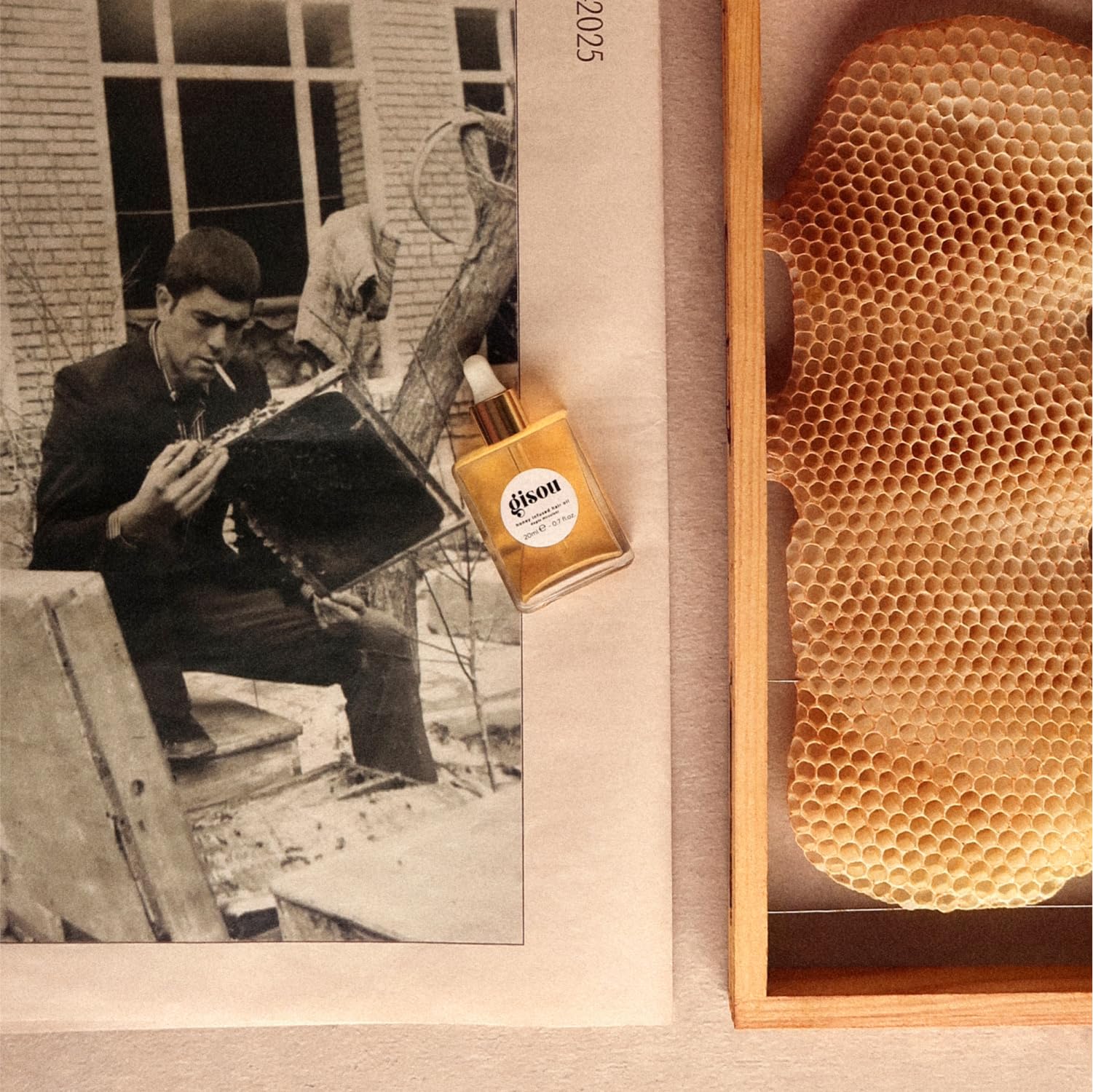 Gisou Honey Infused Hair Oil Mini on hand demonstrates lightweight pre-styling protection