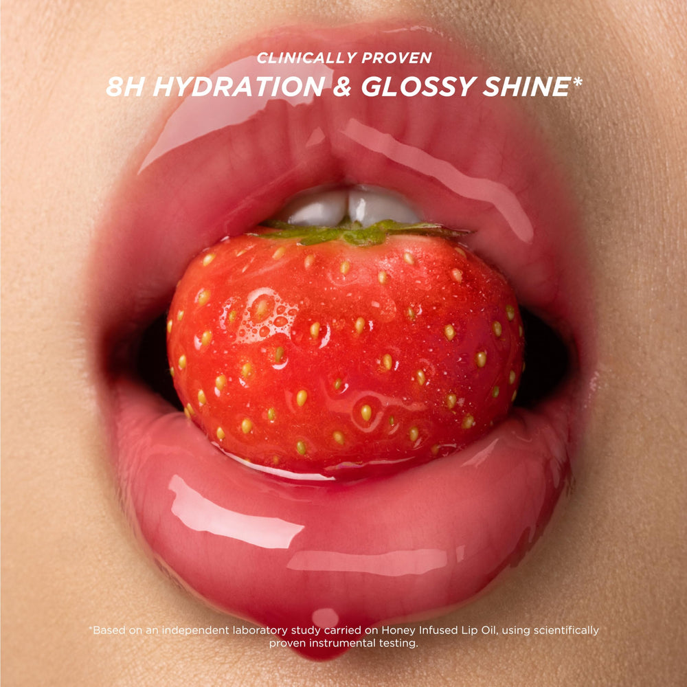 Close-up shows honey droplets highlighting the nourishing formula in Gisou lip oil.