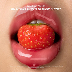 Close-up shows honey droplets highlighting the nourishing formula in Gisou lip oil.