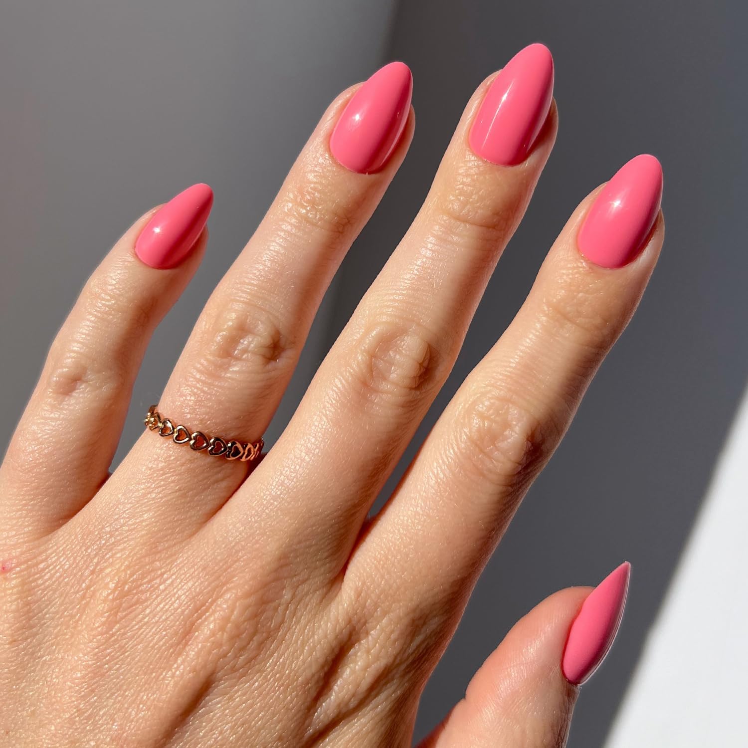 Glamnetic flamingo-pink nails close-up showing vibrant opaque pink color for everyday wear