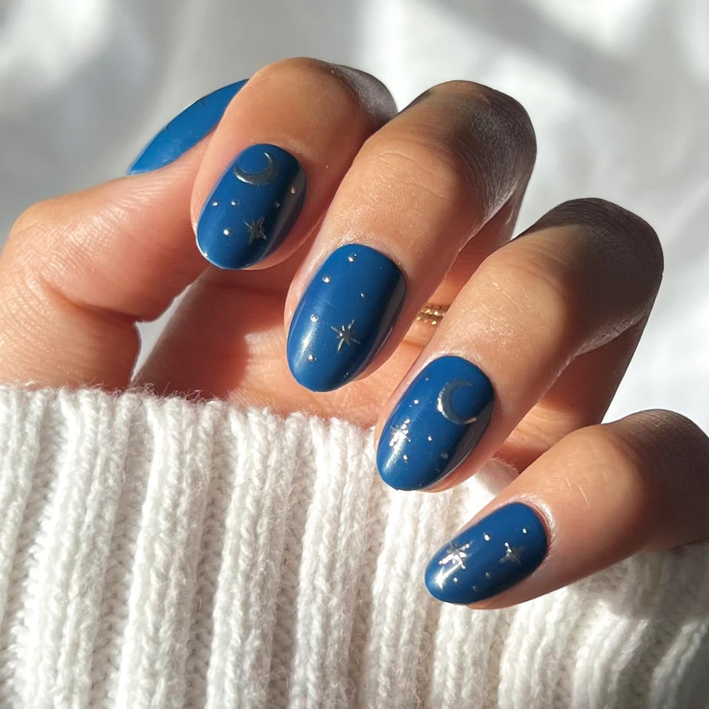 Glamnetic Luna Lovegood nails with blue moon and star graphics for celestial flair.