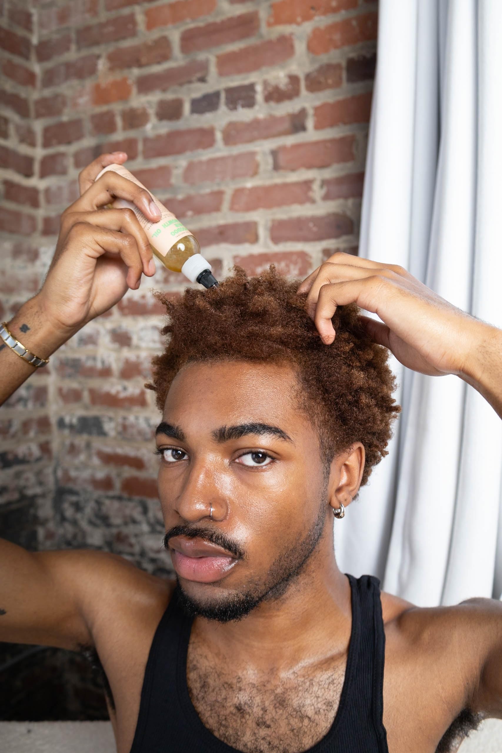 Glossed by Nae Voodoo Hair Growth Oil texture closeup emphasizes smooth, non-greasy finish