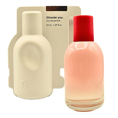 Glossier You eau de parfum bottle closeup highlights the thumbprint detail for a personal scent identity