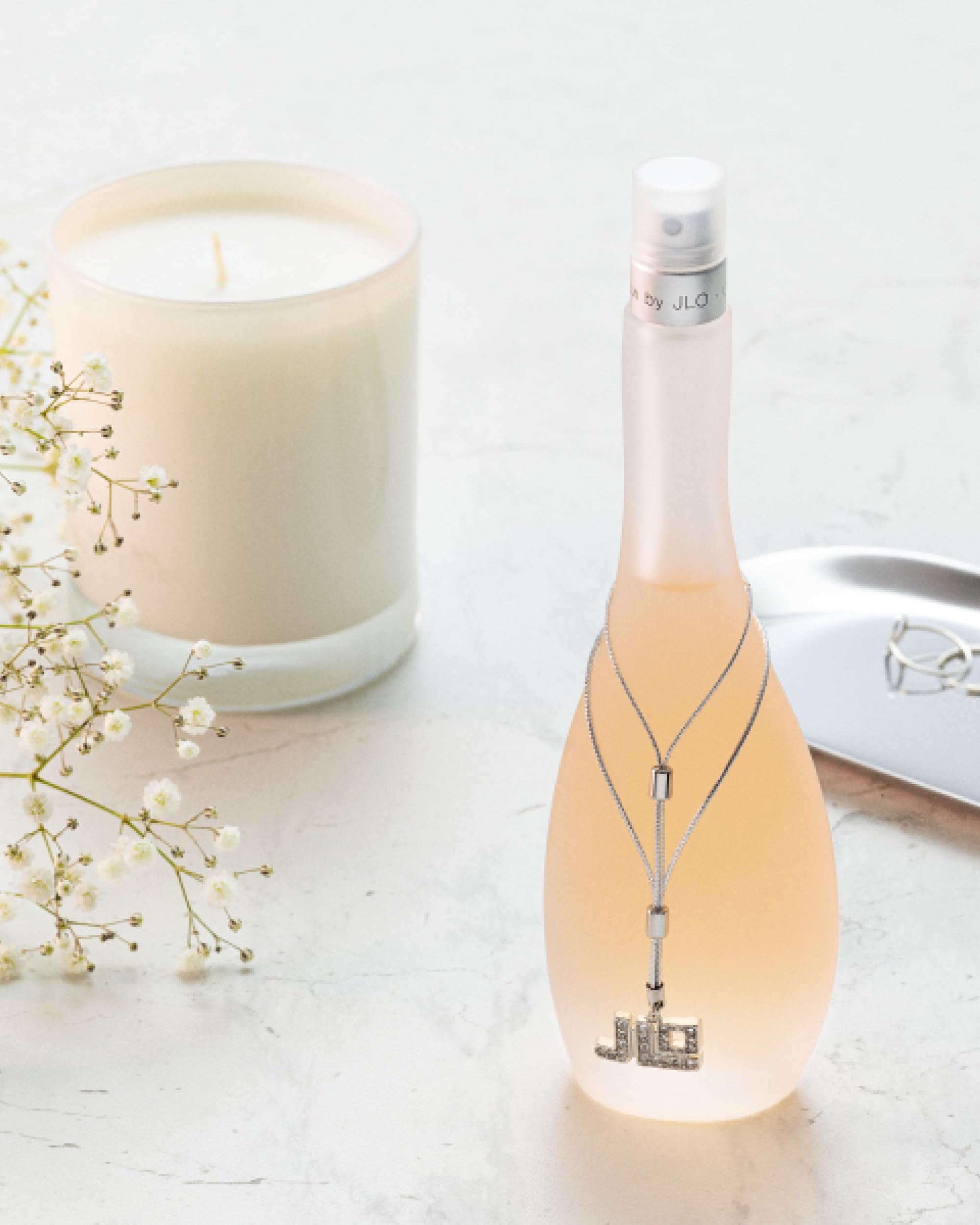 Glow by Jennifer Lopez spray mist captured mid-application for easy use