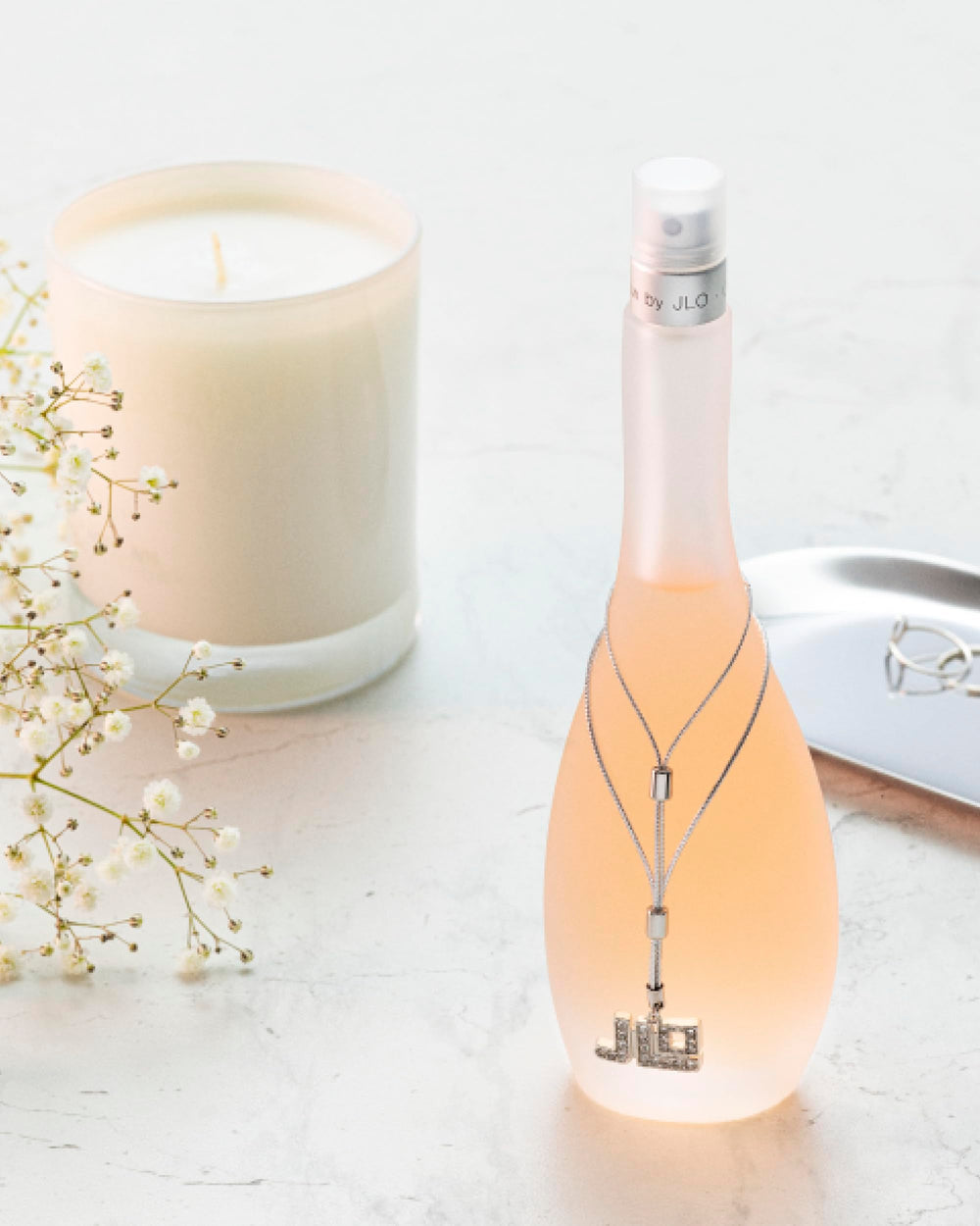 Glow by Jennifer Lopez spray mist captured mid-application for easy use
