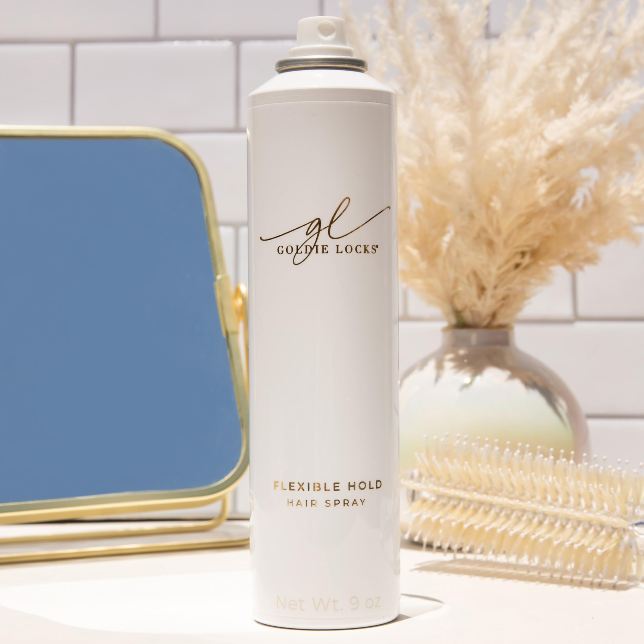 Goldie Locks travel-size hairspray packaging closeup highlights vegan, sulfate-free formula.