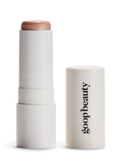 Goop Beauty Glow Skin Highlighter Stick texture closeup shows pearlescent glow on skin.