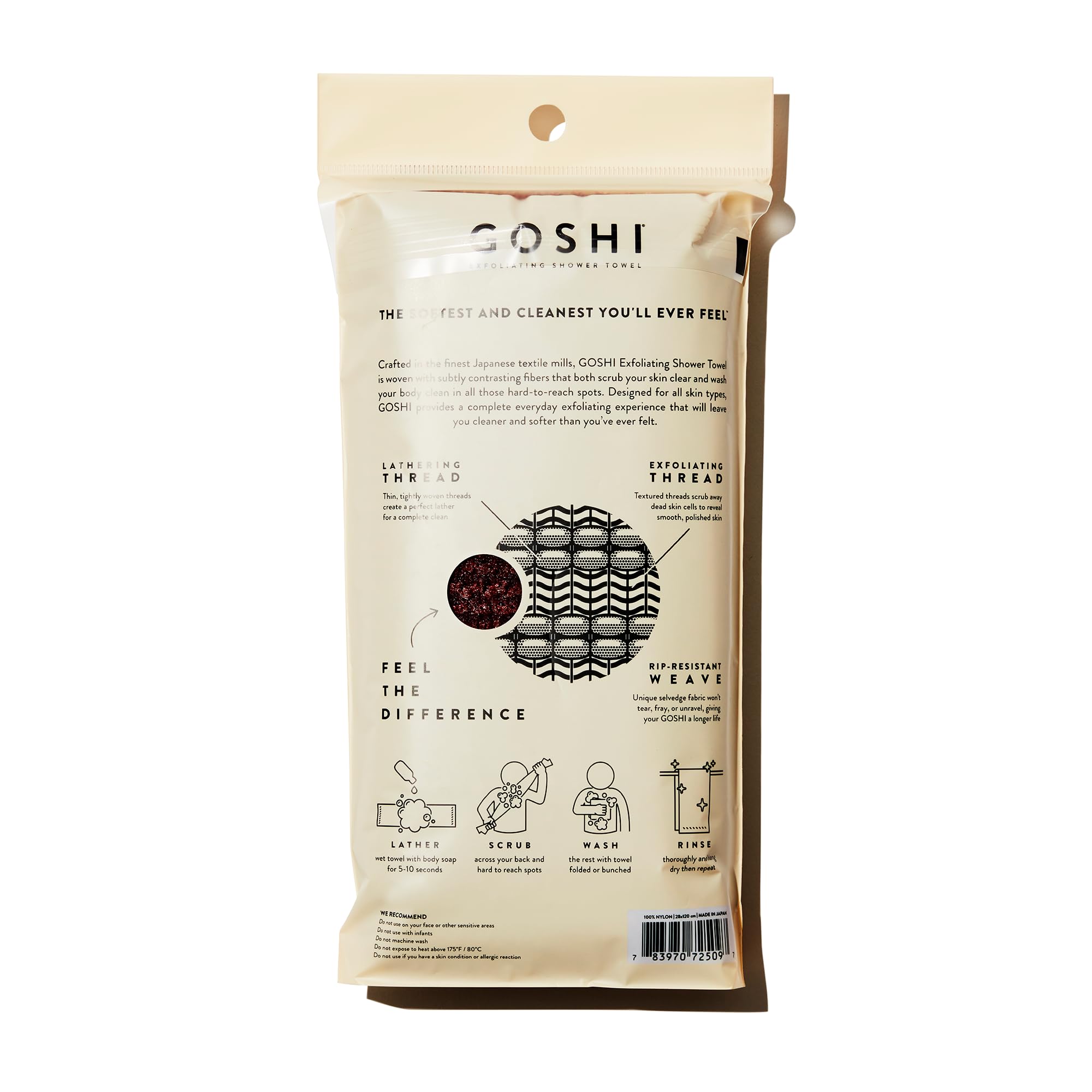 GOSHI exfoliating towel brick-red textured fabric close-up shows dual-thread exfoliation.