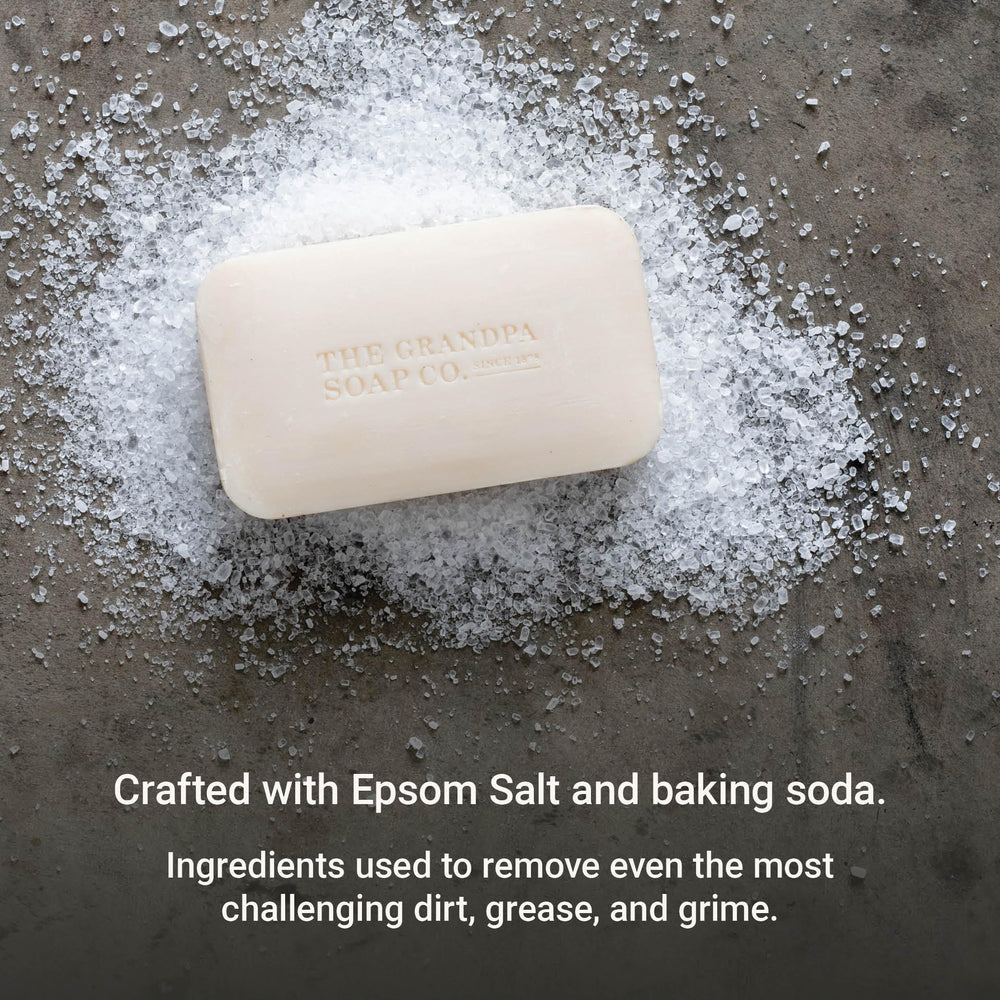 Closeup reveals gritty Epsom salt texture for deeper cleansing with The Grandpa Soap Company.