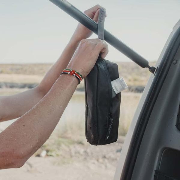 Gravel mini hanging toiletry bag in-use in a hotel bathroom for convenient access