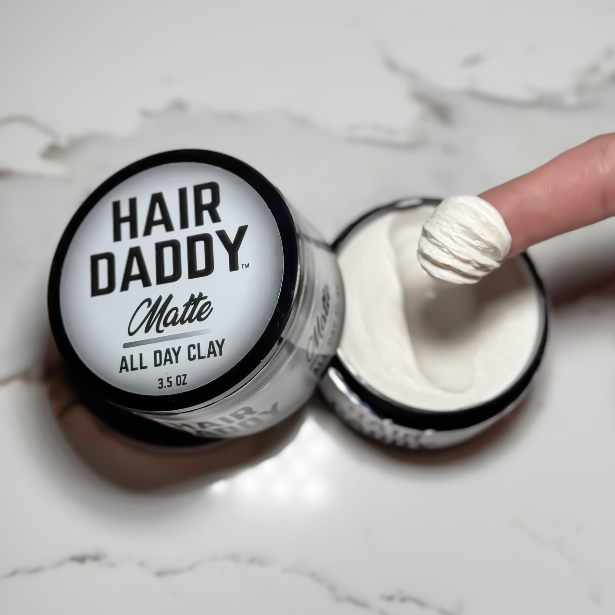 Hair Daddy styling clay no shine finish close-up emphasizes natural matte look.
