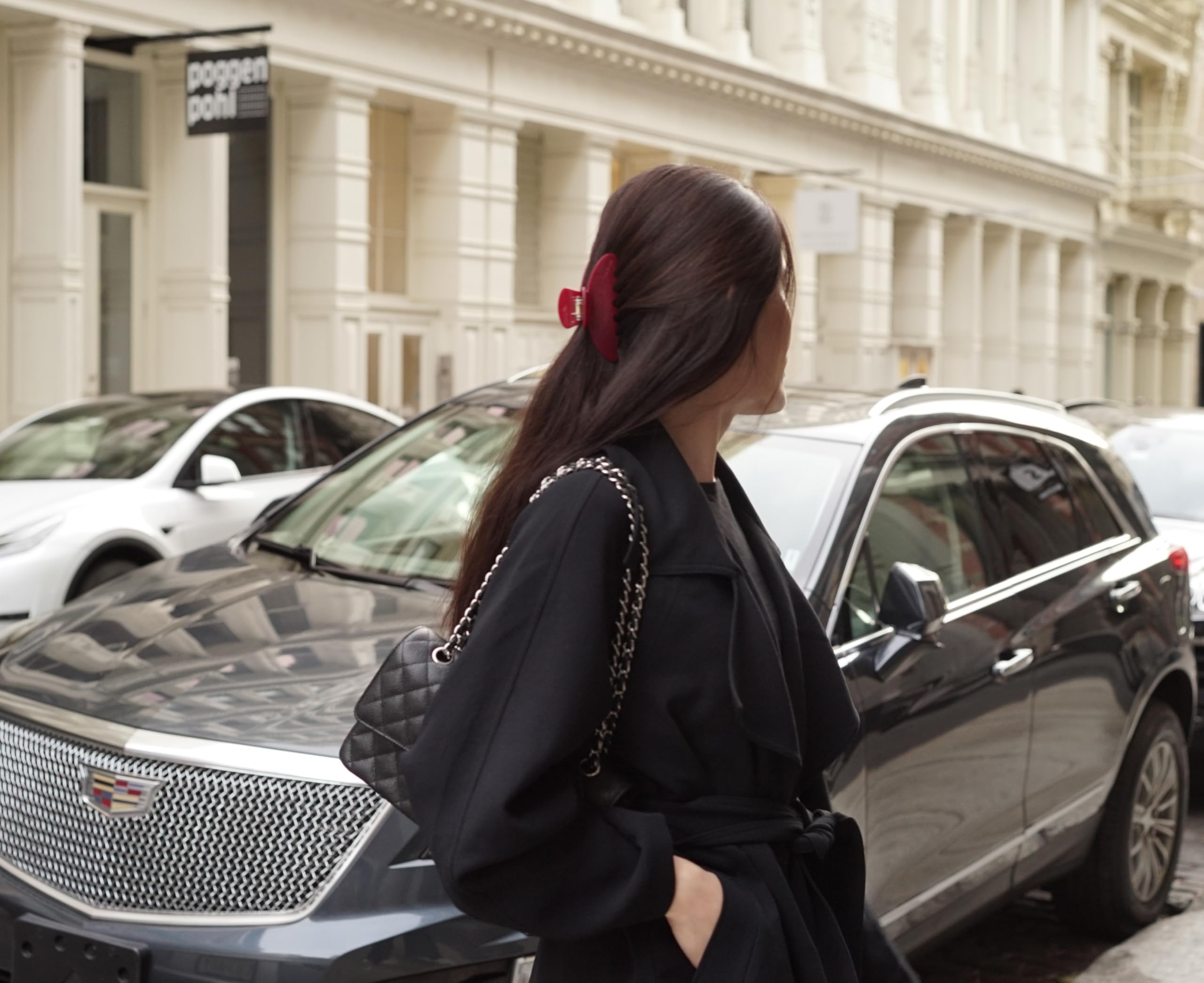 Hana Mia red claw clip in hand demonstrates secure grip for half-up styling