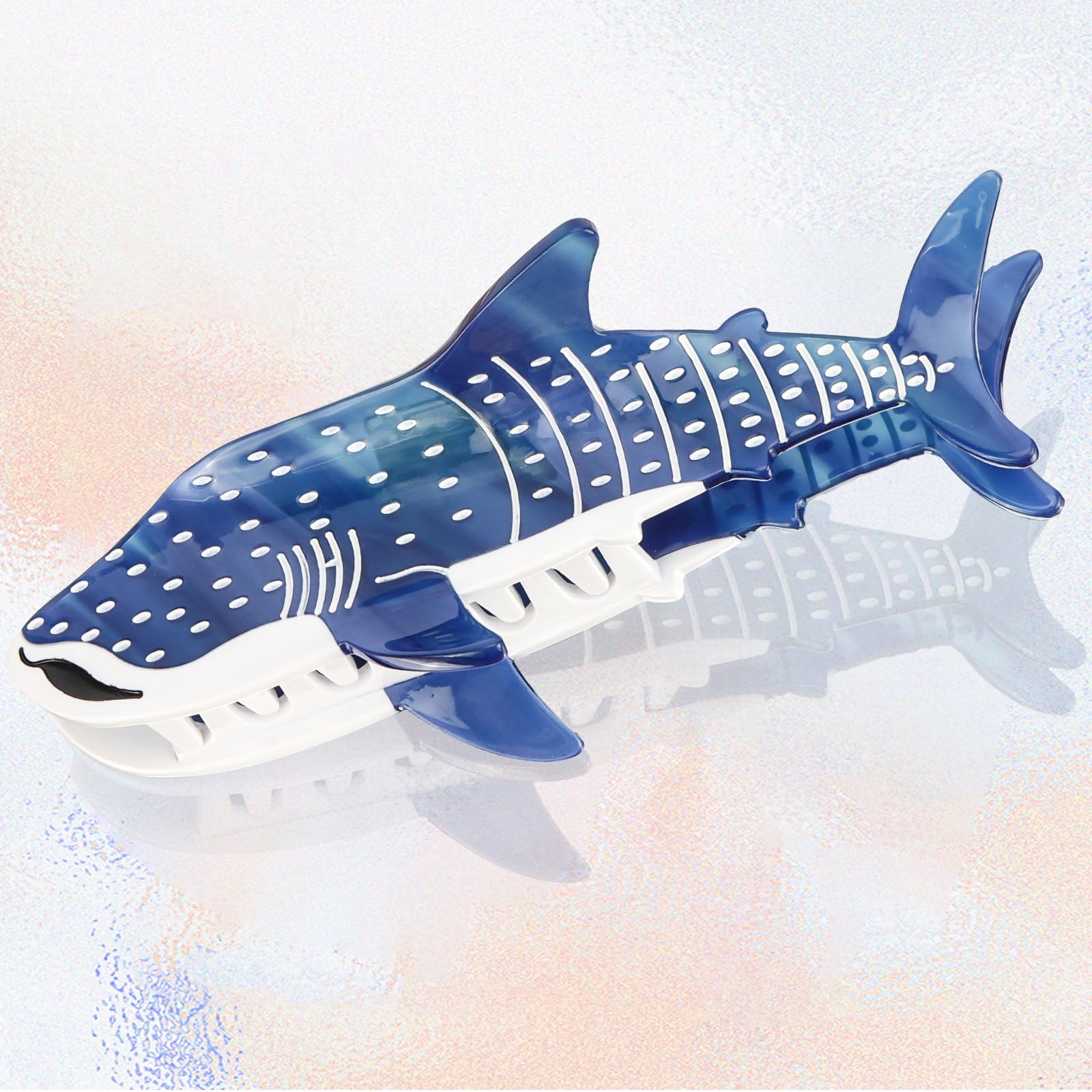 Hapdoo dark blue shark hair clip held for display with elegant nautical vibe