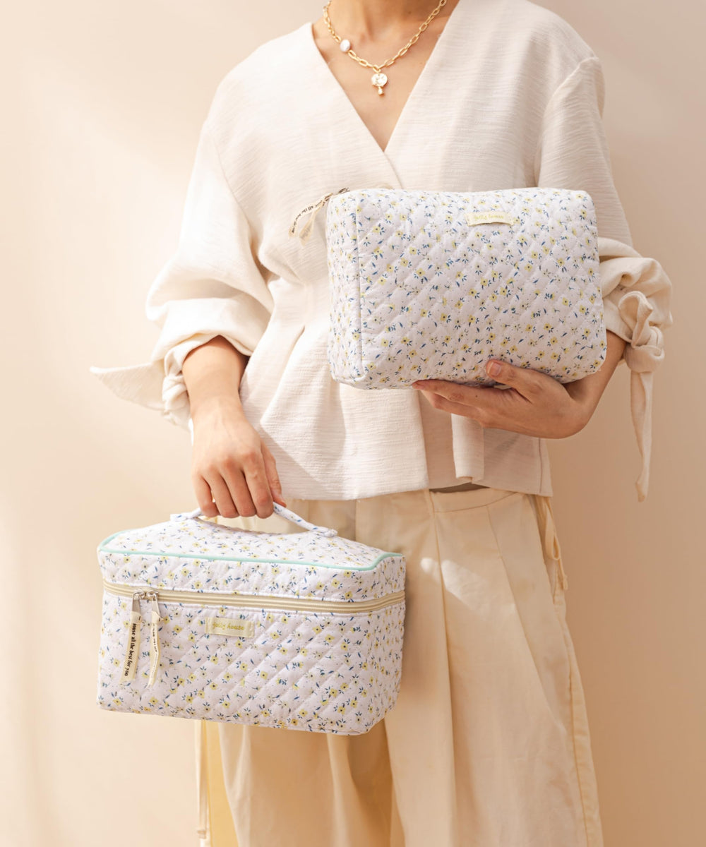 HBselect quilted makeup bag in suitcase display, ideal travel companion.