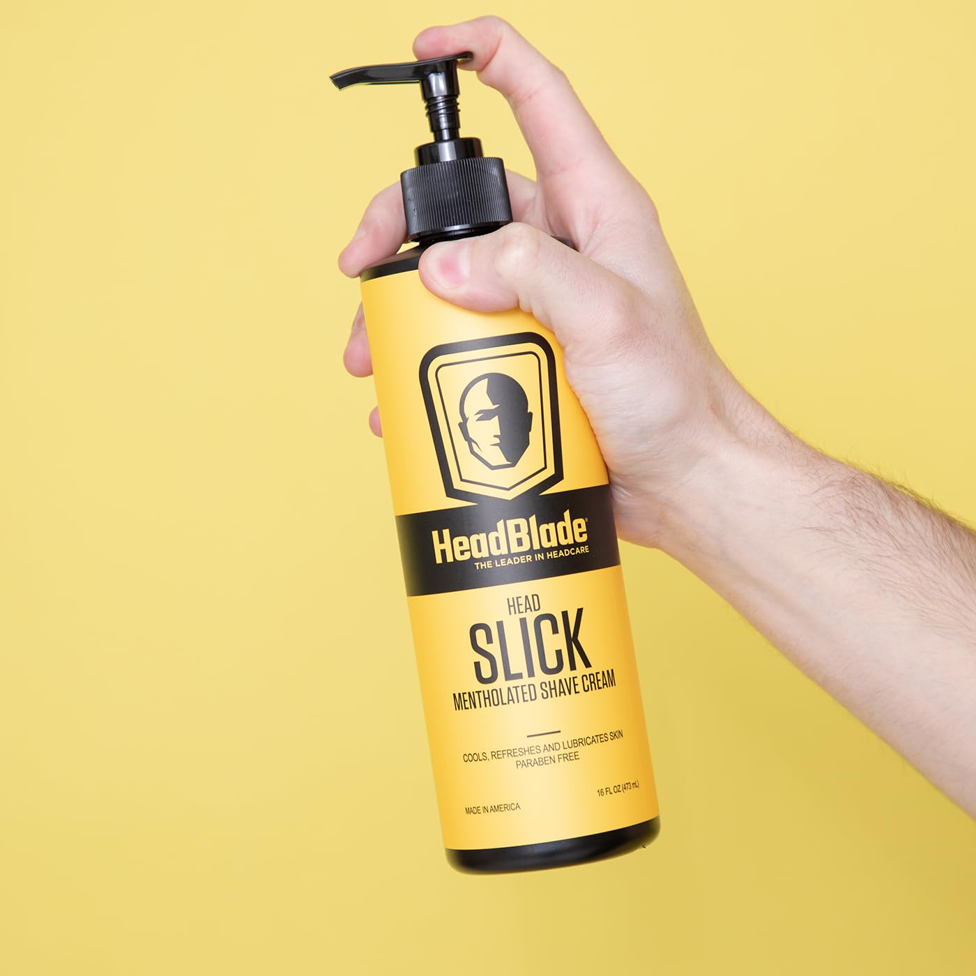 Applying HeadSlick on the scalp with a HeadBlade for smooth glide.
