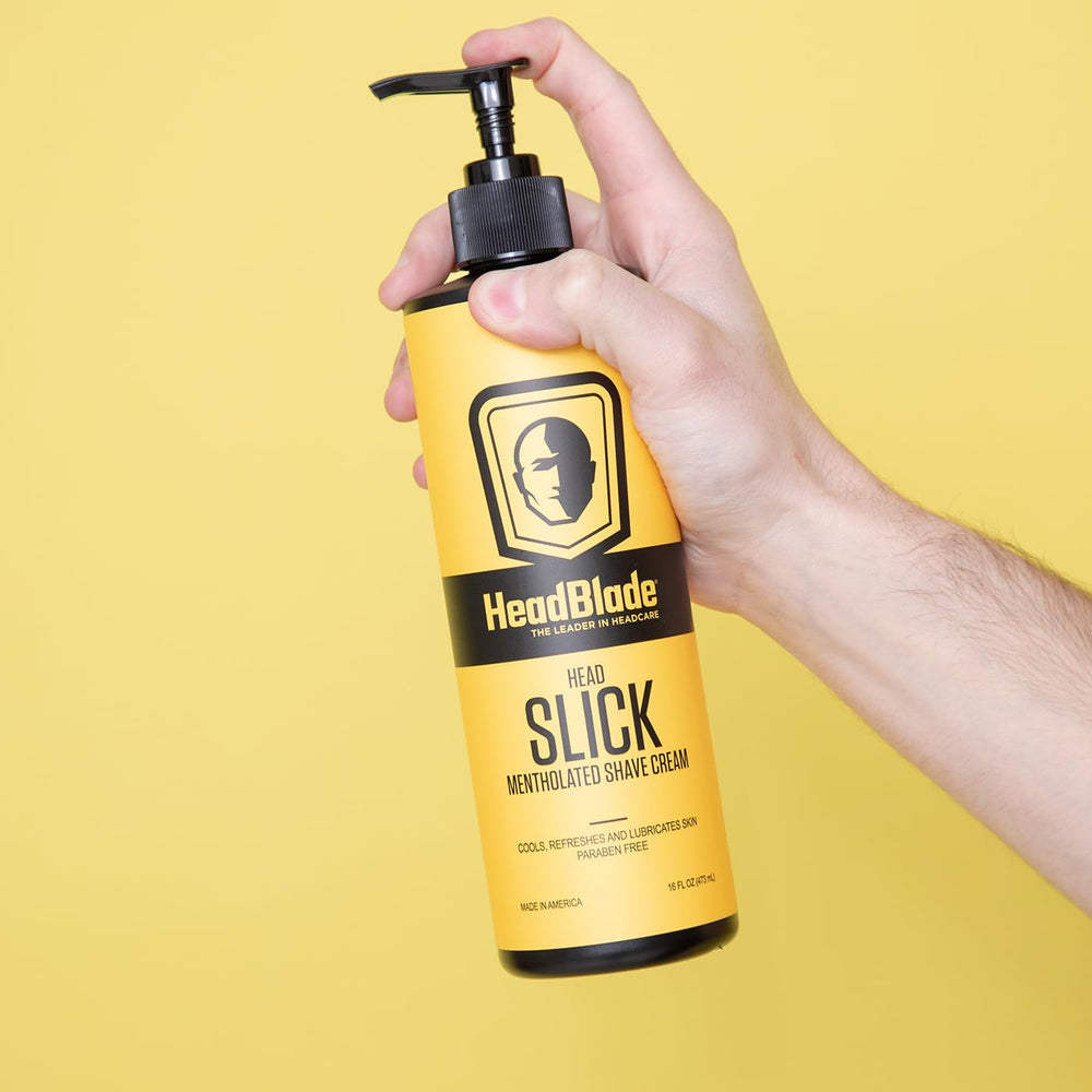 Applying HeadSlick on the scalp with a HeadBlade for smooth glide.