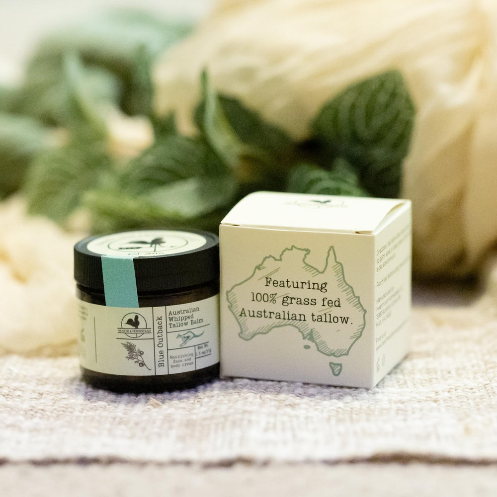 Hearth and Homestead Blue Outback balm bottle with sandalwood and blue cypress signals aromatic relaxation