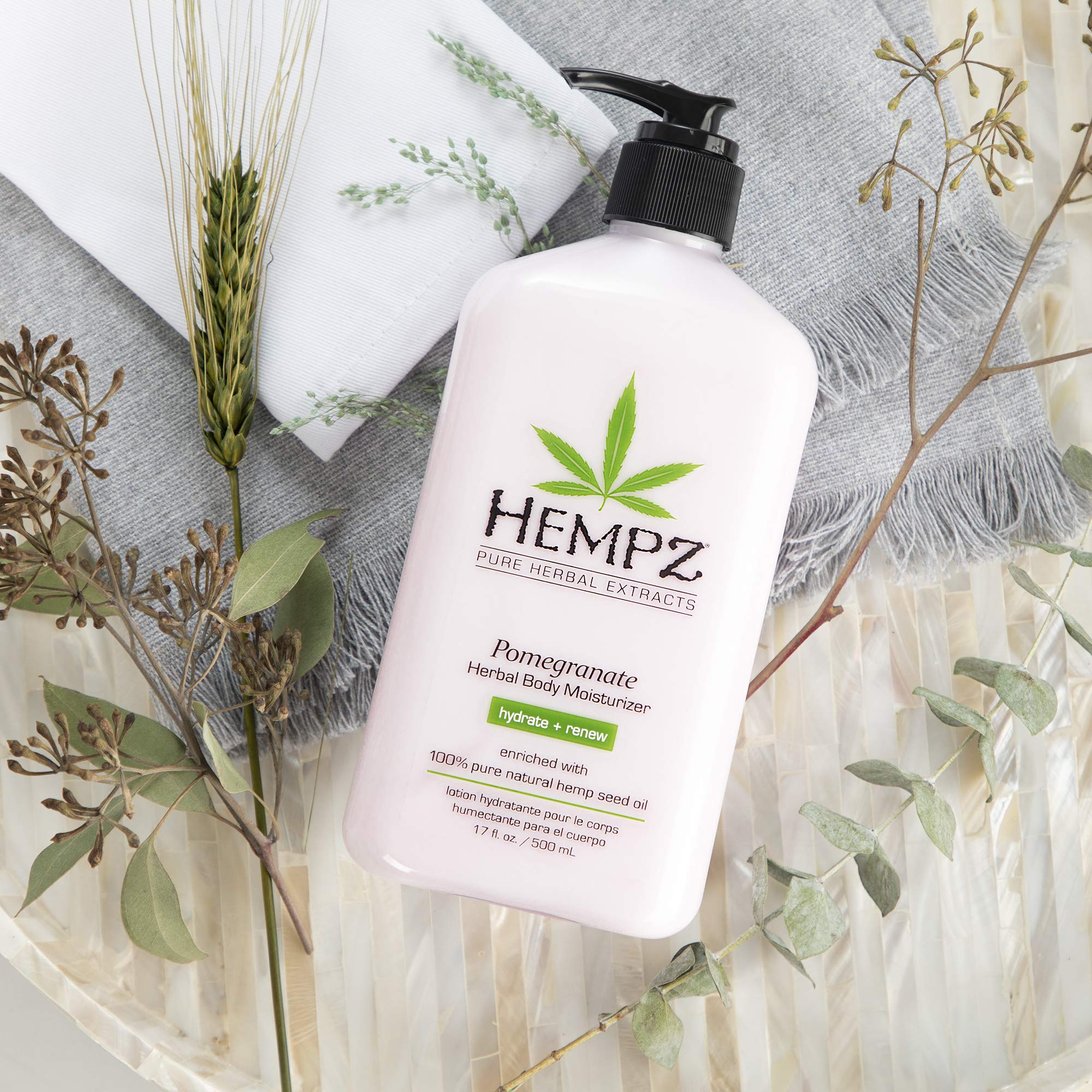 Hempz body lotion pomegranate texture on skin, conveying quick-absorb hydration without residue.