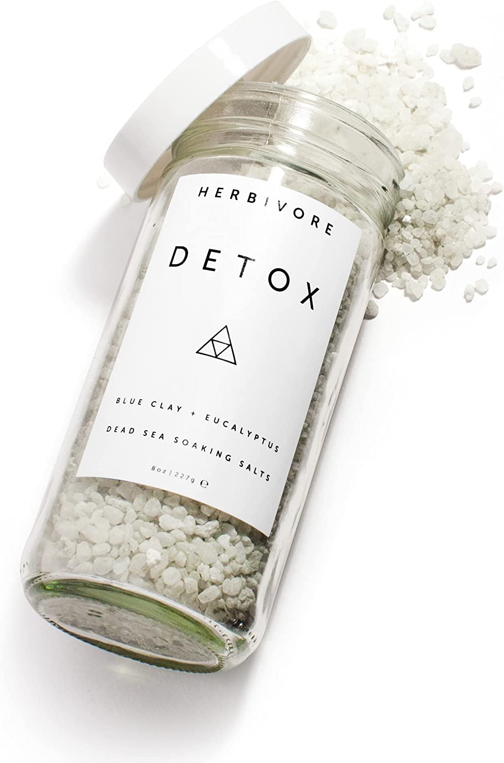 HERBIVORE Detox Soaking Salts in a warm bath creating aromatherapy and relaxation.