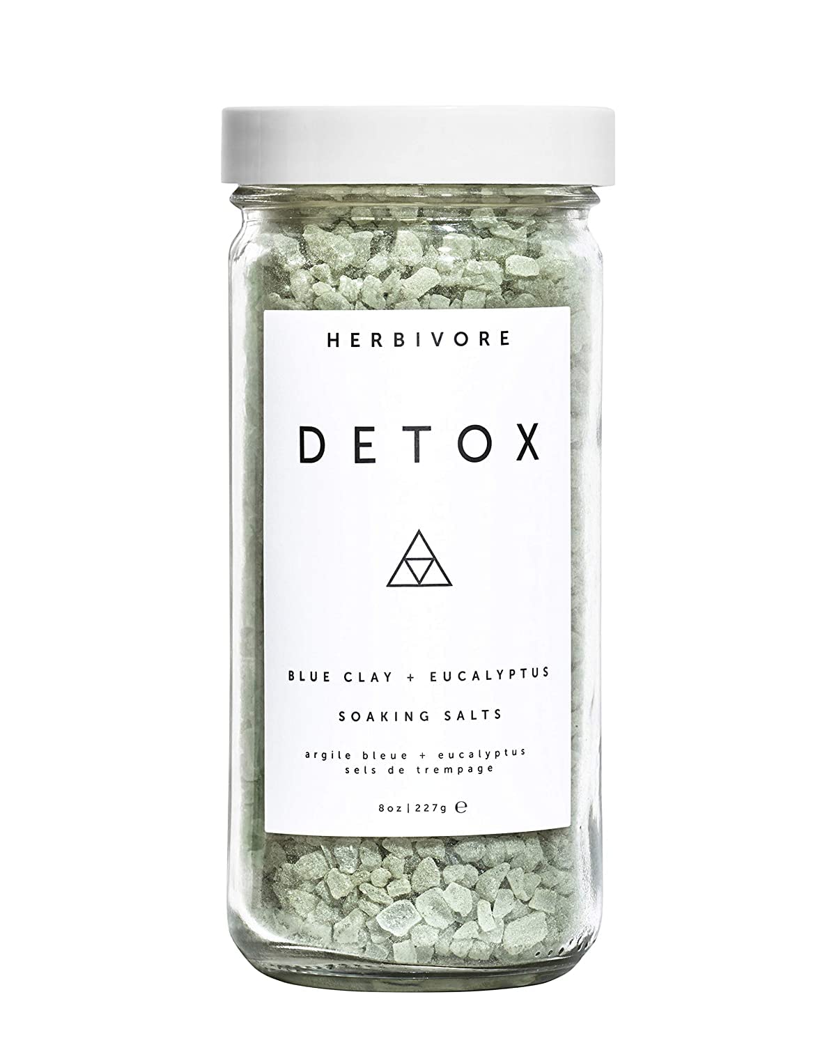 HERBIVORE Detox Soaking Salts bottle pour for a soothing spa-like bath ritual.