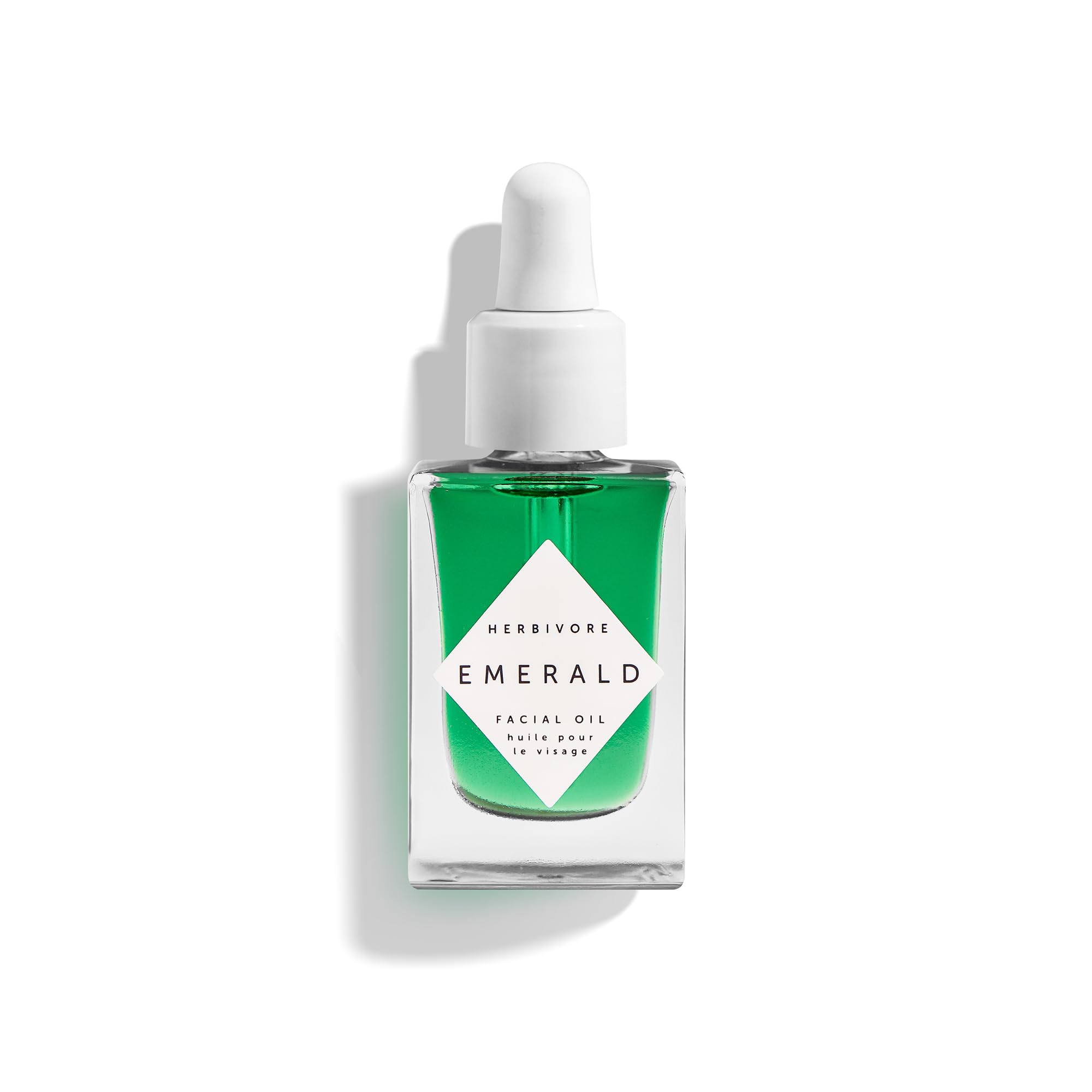 HERBIVORE Emerald Facial Oil bottle for calming, hydrating skin with a radiant glow.
