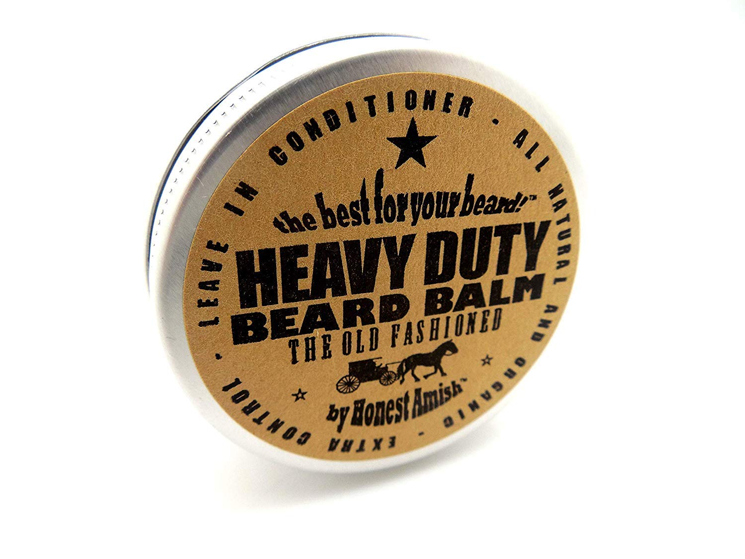 Honest Amish heavy-duty beard balm 2oz label close-up highlighting natural ingredients.