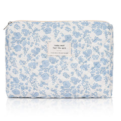 Honitty makeup pouch with quilted floral pattern keeps cosmetics organized while traveling.