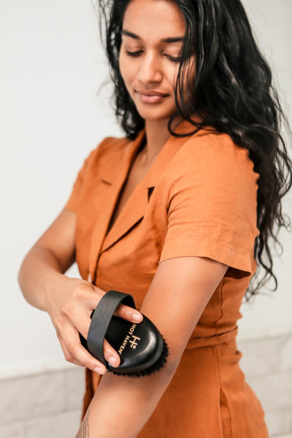 HOT HAVEN Body Brush in use on arm for radiant skin and improved texture