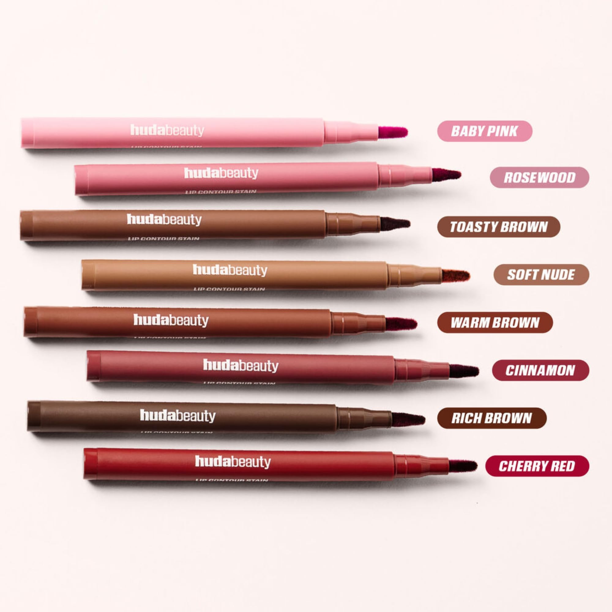 Huda Lip Contour Stain Warm Brown pigment on lips with subtle glow.