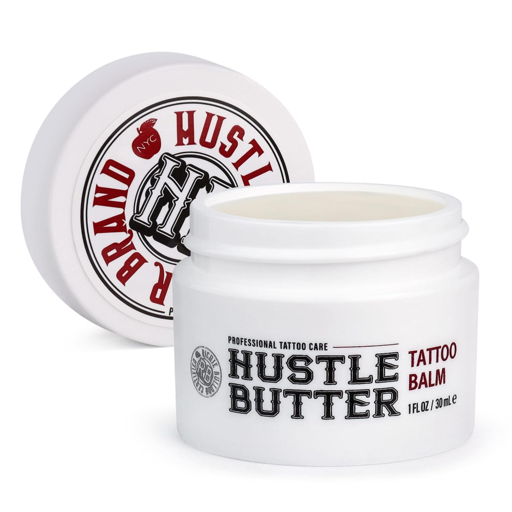 Hustle Butter Deluxe tattoo balm jar close-up showing creamy texture for healing.