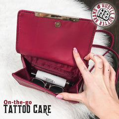 Hustle Butter Deluxe Revitalizing Stick applying to tattoo for on-the-go care
