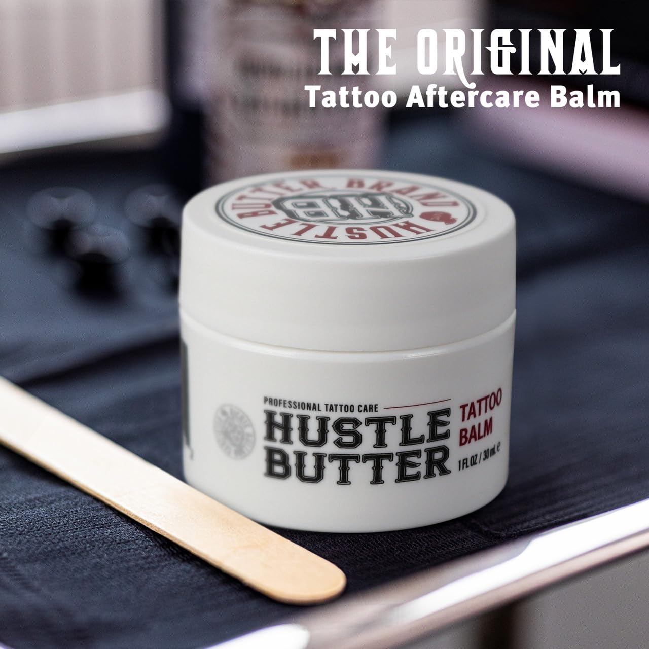 Hustle Butter Deluxe balm texture swatch during tattoo process for smooth glide.