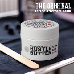 Hustle Butter Deluxe balm texture swatch during tattoo process for smooth glide.
