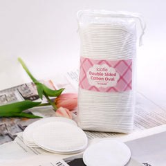 ICOTLE large oval cotton pad in hand demonstrates ergonomic fit for face care.