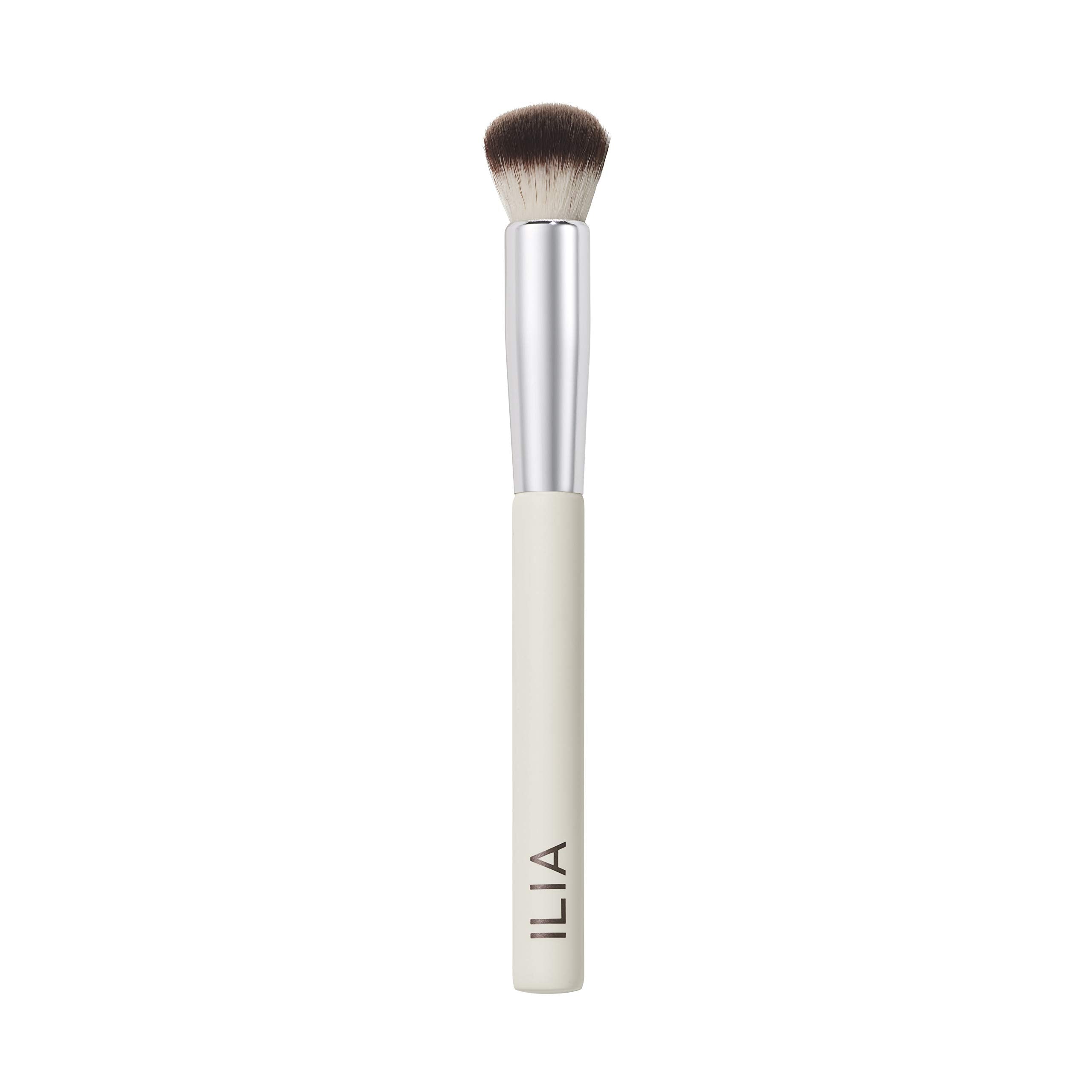 ILIA Complexion Brush with wood handle for precise makeup application on hard-to-reach areas.