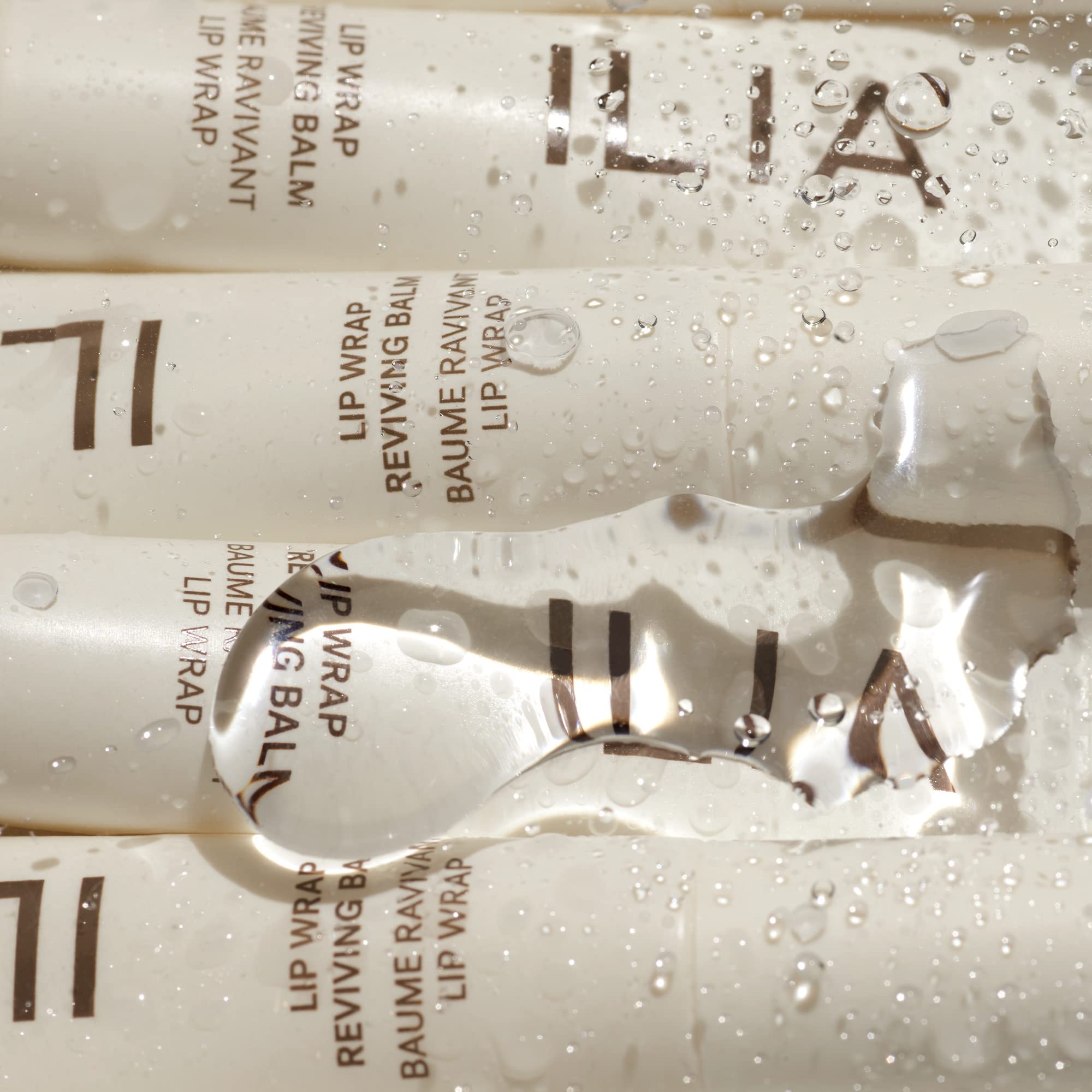 ILIA Lip Wrap Reviving Balm closeup highlights hyaluronic acid for moisture attraction.