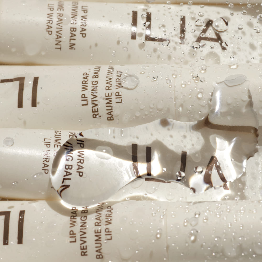 ILIA Lip Wrap Reviving Balm closeup highlights hyaluronic acid for moisture attraction.