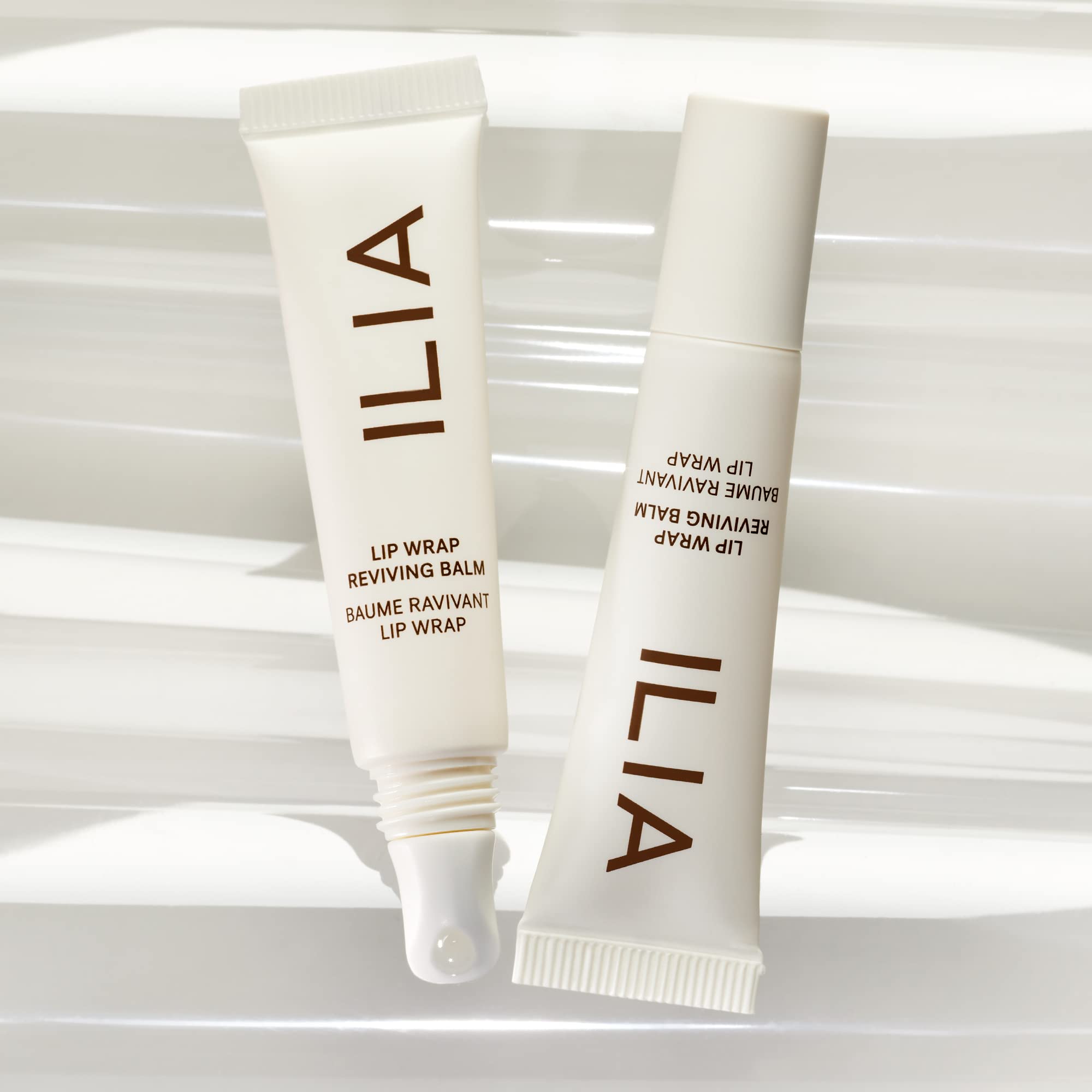 ILIA Lip Wrap Reviving Balm swatch on wrist shows subtle sheen and moisture.