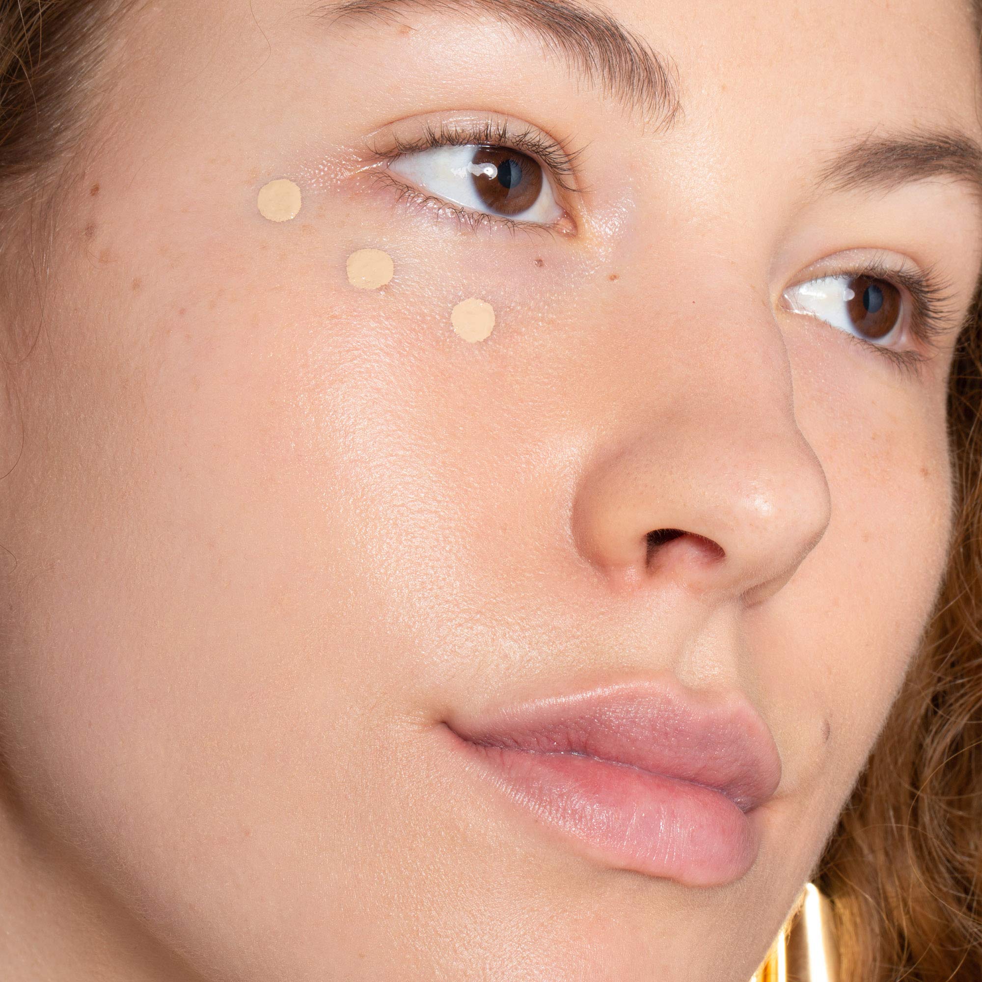 ILIA True Skin Serum Concealer applied to blemish for natural coverage.