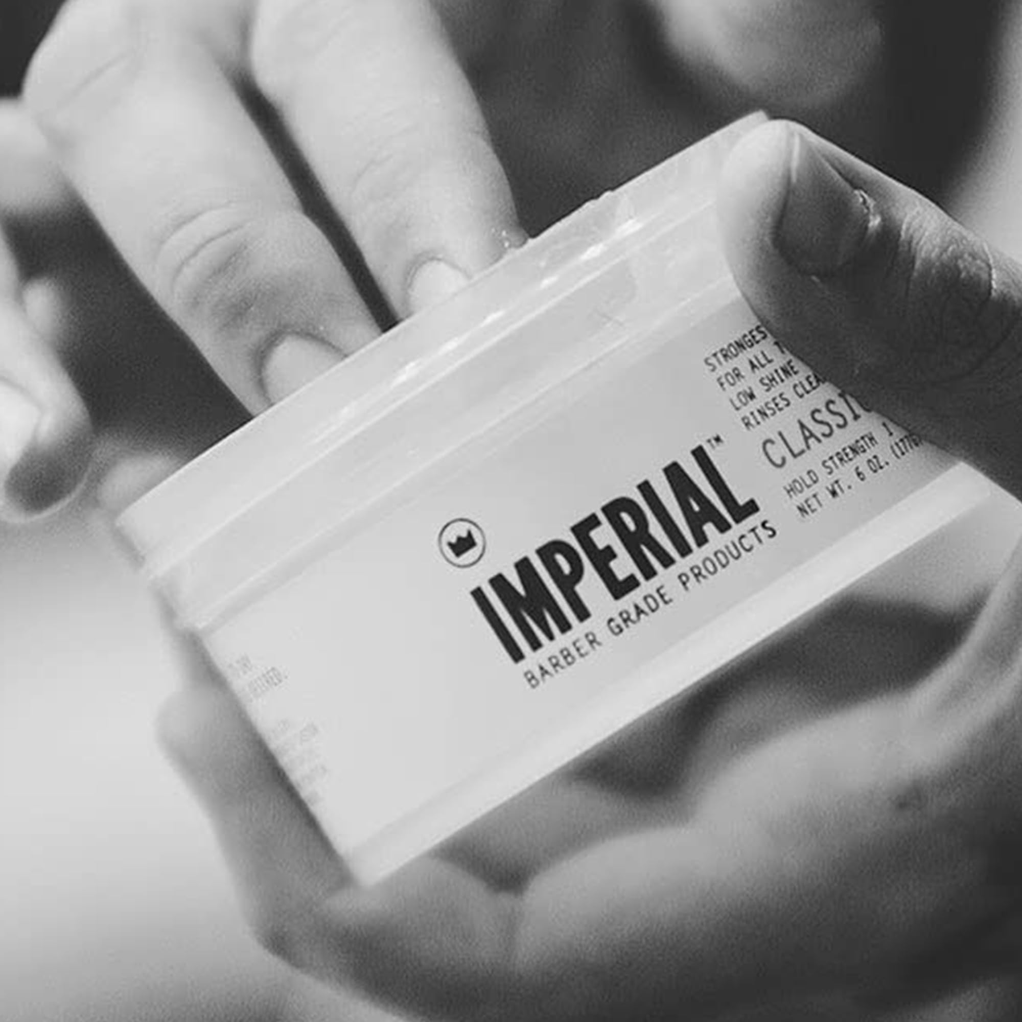 Imperial Classic Pomade scooped and warmed in hand for easy application
