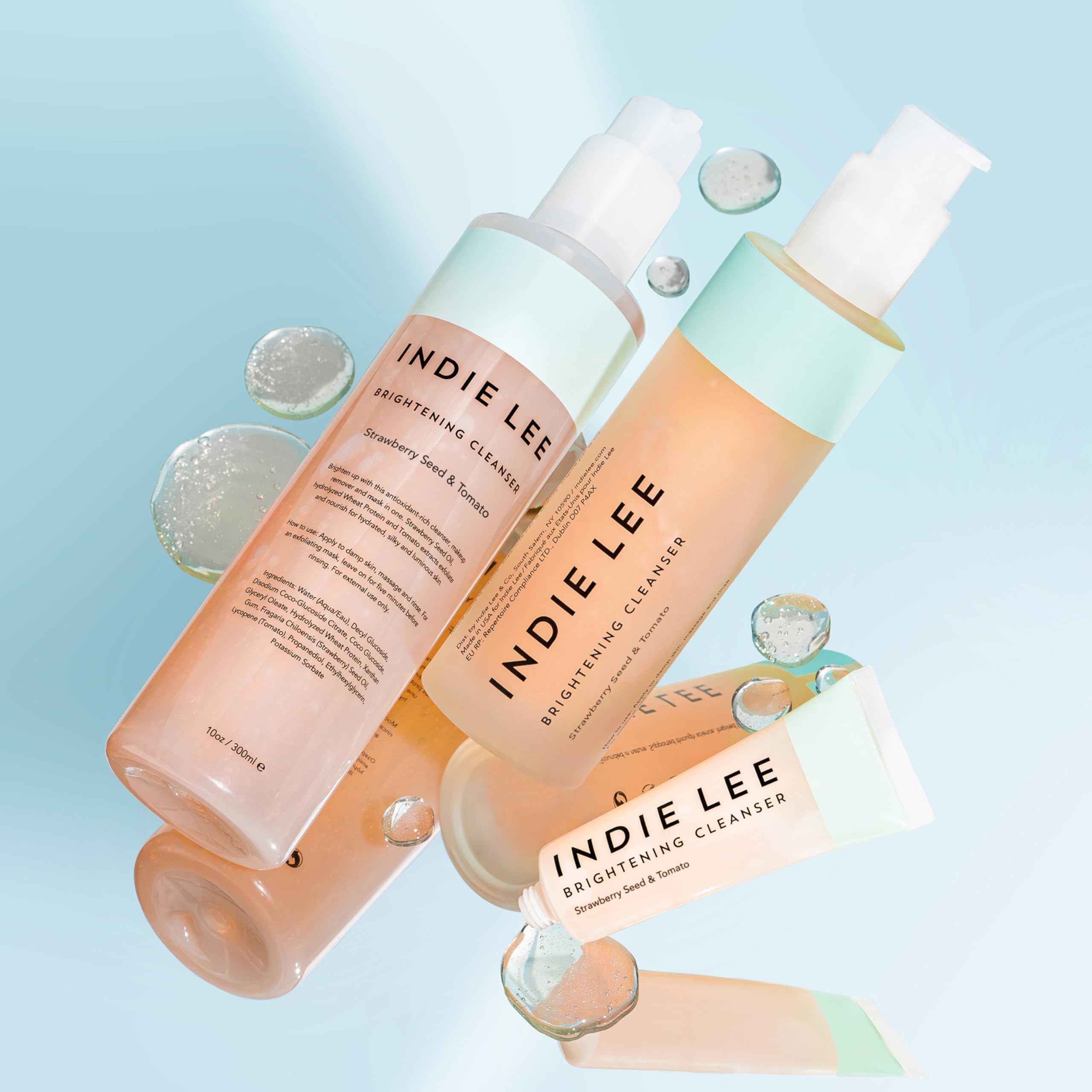 Indie Lee Brightening Cleanser applying makeup removal on skin.