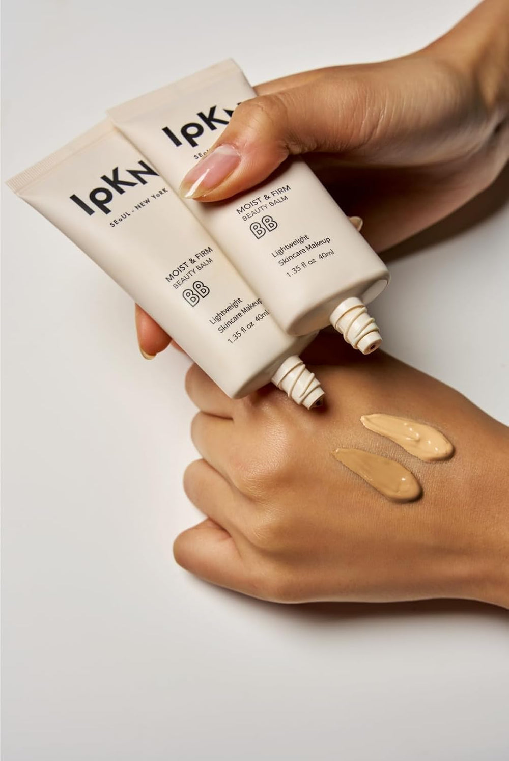 IPKN Moist & Firm BB Cream texture swirl showcases creamy consistency for easy application.