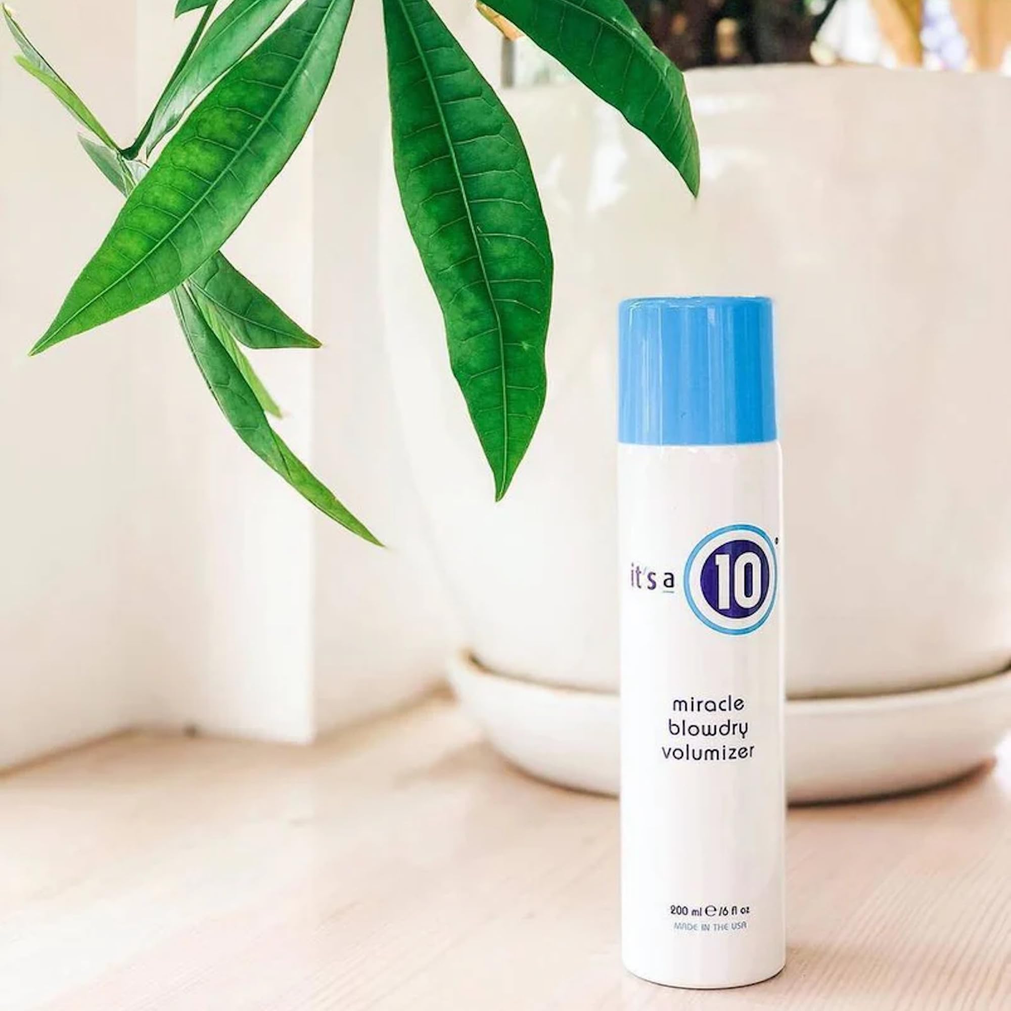 Its A 10 Miracle Blowdry Volumizer 6 Oz bottle demonstrates easy-to-use styling for quick mornings.